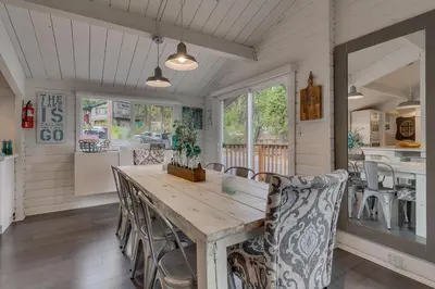 a dining room with a wooden table and chairs at Blackwood Bungalow on the West Shore by Tahoe Getaways - 3 BR Pet Friendly & Walking Distance to the Lake in Homewood