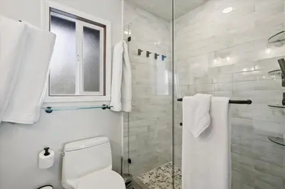 a bathroom with a toilet and a glass shower at Cobalt Cabin by Tahoe Getaways - Beautifully Remodeled Pet Friendly 3 BR with Hot Tub & EV in Carnelian Bay