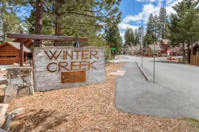 a sign that reads winter creek next to a street at Cedar Crest at Winter Creek by Tahoe Getaways - 3BR, Walk to Ice Skating, Near Downtown and Northstar with Private Hot Tub! in Truckee
