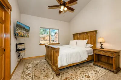 a bedroom with a bed and a ceiling fan at Cedar Crest at Winter Creek by Tahoe Getaways - 3BR, Walk to Ice Skating, Near Downtown and Northstar with Private Hot Tub! in Truckee
