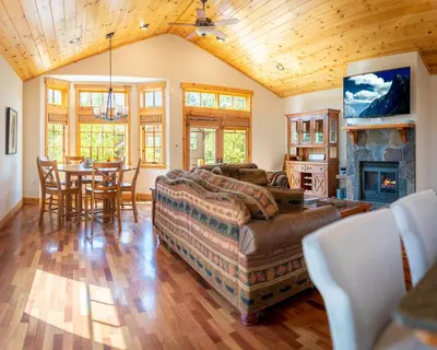 a living room with a couch and a table at Coyote Run Retreat by Tahoe Getaways - 3BR Pet Friendly with HOA Amenities, Minutes to Downtown Truckee & Northstar Resort! in Truckee