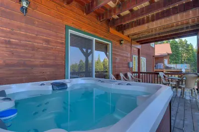 a jacuzzi tub in a house with a patio at Crystal Lakeview Lodge by Tahoe Getaways - Private Hot Tub, Foosball Table & Tahoe Park HOA in Tahoe City
