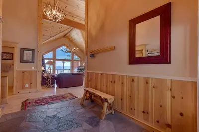 a living room with a mirror and a bench at Crystal Lakeview Lodge by Tahoe Getaways - Private Hot Tub, Foosball Table & Tahoe Park HOA in Tahoe City