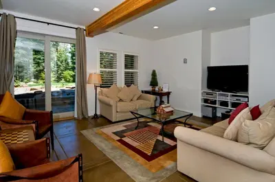 a living room with two couches and a television at Big Springs by Tahoe Getaways - 6BR w Ski Shuttle, Fireplace & Entertainment Room in Truckee
