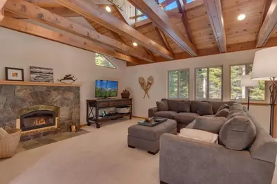 a living room with a couch and a fireplace at Deer Hollow by Tahoe Getaways at Northstar - 4BR w Hot Tub, Ski Shuttle, & HOA Amenities in Truckee