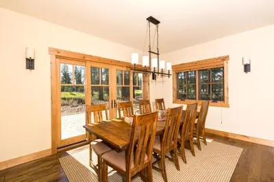 a dining room with a wooden table and chairs at Caleb's Getaway by Tahoe Getaways at Old Greenwood- 3BR w Bonus Room, Pets Welcome & Ski Shuttle! in Truckee
