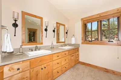 a bathroom with two sinks and two mirrors at Caleb's Getaway by Tahoe Getaways at Old Greenwood- 3BR w Bonus Room, Pets Welcome & Ski Shuttle! in Truckee
