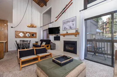 a living room with a couch and a fireplace at Epic Condo walk to Canyon Lodge in Mammoth Lakes
