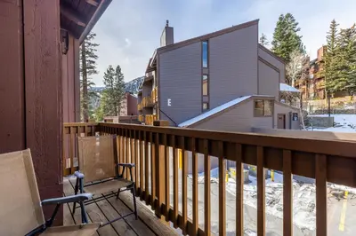 a balcony with a bench and a house at Epic Condo walk to Canyon Lodge in Mammoth Lakes