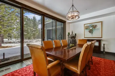 a dining room with a wooden table and chairs at Allure at Schaffer's Mill by Tahoe Getaways - 4BR Pet-Friendly Home w Private Hot Tub & Air Conditioning! in Truckee