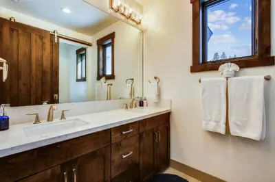 a bathroom with a sink and a mirror at Allure at Schaffer's Mill by Tahoe Getaways - 4BR Pet-Friendly Home w Private Hot Tub & Air Conditioning! in Truckee