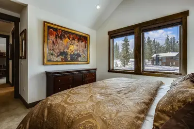 a bedroom with a bed and a picture on the wall at Allure at Schaffer's Mill by Tahoe Getaways - 4BR Pet-Friendly Home w Private Hot Tub & Air Conditioning! in Truckee