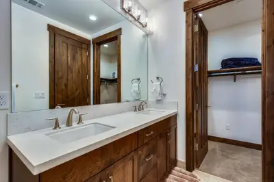a bathroom with a sink and a mirror at Allure at Schaffer's Mill by Tahoe Getaways - 4BR Pet-Friendly Home w Private Hot Tub & Air Conditioning! in Truckee