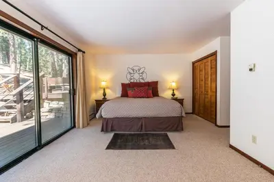 a bedroom with a bed and a large window at Basque Lodge at Northstar by Tahoe Getaways - Pet-Friendly 5BR w Free Shuttle & HOA Amenities in Truckee