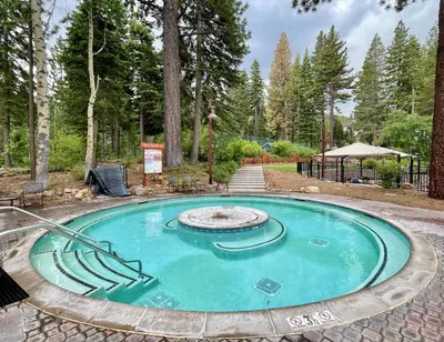 a small pool with a fountain in the middle at Basque Lodge at Northstar by Tahoe Getaways - Pet-Friendly 5BR w Free Shuttle & HOA Amenities in Truckee