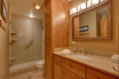 a bathroom with a sink and a toilet and a mirror at Club 151 at Dollar Point by Tahoe Getaways - Pet-Friendly 4BR w Hot Tub & Fenced Yard in Tahoe City