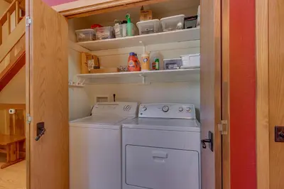 a washer and dryer in a small kitchen at Club 151 at Dollar Point by Tahoe Getaways - Pet-Friendly 4BR w Hot Tub & Fenced Yard in Tahoe City