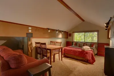 a living room with a table and a bed and a bedroom at Club 151 at Dollar Point by Tahoe Getaways - Pet-Friendly 4BR w Hot Tub & Fenced Yard in Tahoe City