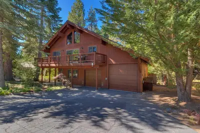 a house with a balcony and a garage at Club 151 at Dollar Point by Tahoe Getaways - Pet-Friendly 4BR w Hot Tub & Fenced Yard in Tahoe City