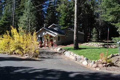 a house on the side of a road at Glades Getaway by Tahoe Getaways - Charming Pet-Friendly 3 BD North Shore Cabin w Wood Fireplace & Short Drive to Ski Resorts in Carnelian Bay