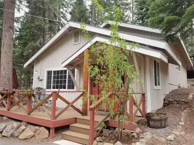 a tiny house with a porch and a deck at Glades Getaway by Tahoe Getaways - Charming Pet-Friendly 3 BD North Shore Cabin w Wood Fireplace & Short Drive to Ski Resorts in Carnelian Bay