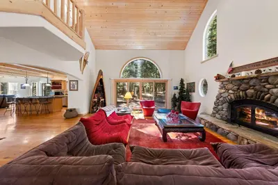 a living room with a couch and a fireplace at Fox Crossing at Tahoe Donner by Tahoe Getaways - 3BR Vacation Rental w Forested Views & HOA Amenities! in Truckee
