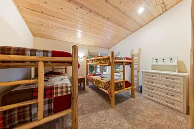 a bedroom with two bunk beds in a house at Fox Crossing at Tahoe Donner by Tahoe Getaways - 3BR Vacation Rental w Forested Views & HOA Amenities! in Truckee