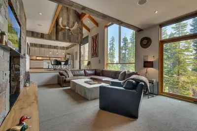 a living room with a couch and a fireplace at Mod Haus by Tahoe Getaways - Mountain Modern West Shore Home w Private Beach and Pier, Near Skiing in Homewood