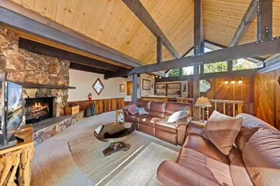 a living room with a couch and a fireplace at Nightingale Retreat by Tahoe Getaways - 3BR, Close to Tahoe City, Walk to Bike Path & Private Beach Access in Tahoe City