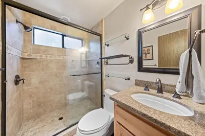 a bathroom with a shower and a sink and a toilet at Nightingale Retreat by Tahoe Getaways - 3BR, Close to Tahoe City, Walk to Bike Path & Private Beach Access in Tahoe City
