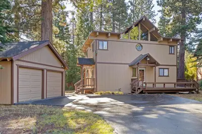 a house with a garage and a driveway at Nightingale Retreat by Tahoe Getaways - 3BR, Close to Tahoe City, Walk to Bike Path & Private Beach Access in Tahoe City