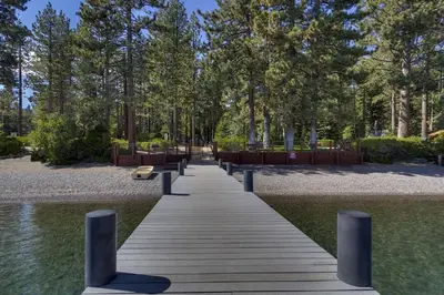 a wooden bridge over the water in a park at Sunlit Pines by Tahoe Getaways - 2BR in Tahoe Park w Hot Tub, Fenced Yard & Pet Friendly! in Tahoe City