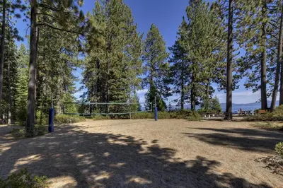 a volleyball net in a park with trees at Sunlit Pines by Tahoe Getaways - 2BR in Tahoe Park w Hot Tub, Fenced Yard & Pet Friendly! in Tahoe City