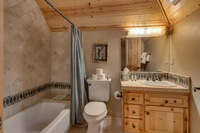 a bathroom with a tub and a toilet and a sink at Tippy Canoe by Tahoe Getaways - 4BR West Shore w Private Hot Tub,, Sauna, EV & Walking Distance to Trailhead in Tahoma
