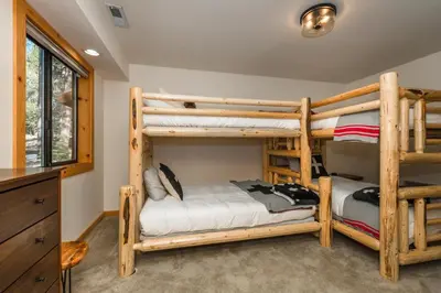 a bedroom with two bunk beds in a house at Tree Haus by Tahoe Getaways - Unique Pet-Friendly Tahoe Donner Home w EV & HOA Pool & Beach in Truckee