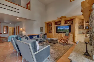 a living room with a couch and a table at Tranquil Retreat by Tahoe Getaways - 3BR Pet-Friendly Home w Private Hot Tub, Views & HOA Amenities in Truckee