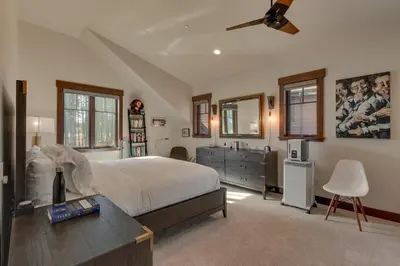 a bedroom with a bed and a desk and a sink at Truckee Luxe by Tahoe Getaways - 3 BR Luxury Gray's Crossing Townhome w Hot Tub on Golf Course - Close to Downtown & Northstar in Truckee