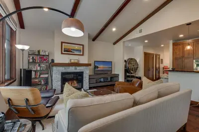 a living room with a couch and a fireplace at Truckee Luxe by Tahoe Getaways - 3 BR Luxury Gray's Crossing Townhome w Hot Tub on Golf Course - Close to Downtown & Northstar in Truckee
