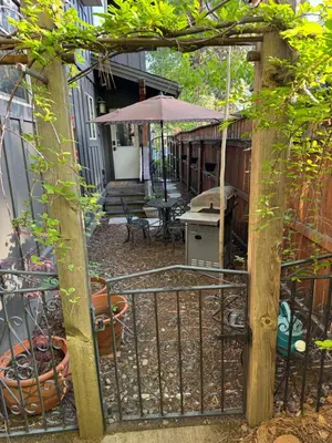 an open gate to a patio with an umbrella at Lake Tahoe Luxury Guest Quarters in South Lake Tahoe