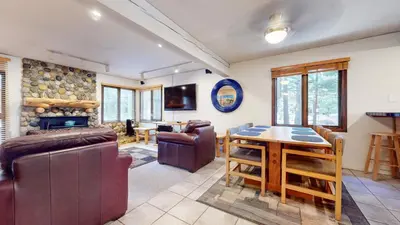 a living room with couches and a table and chairs at Wildflower #51 condo in Mammoth Lakes