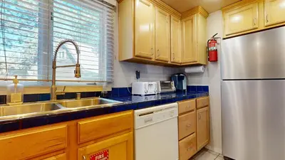 a kitchen with wooden cabinets and a stainless steel refrigerator at Wildflower #51 condo in Mammoth Lakes