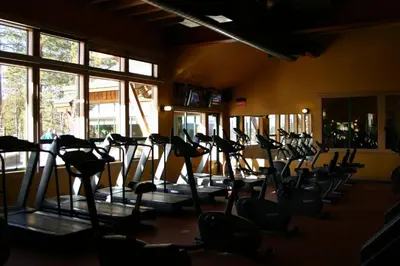 a gym with rows of treadmills in a room at Dogwood Place by Tahoe Getaways - 3BR Pet-Friendly Tahoe Donner Home w Hot Tub, Pool Table, Wood Fireplace & HOA Amenities in Truckee