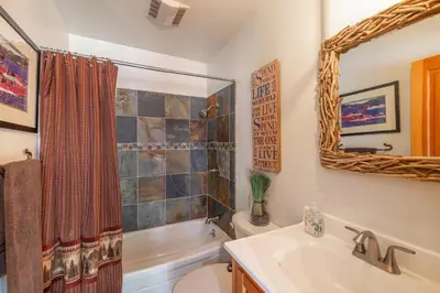 a bathroom with a sink toilet and a mirror at Ember Ridge Retreat by Tahoe Getaways - 3BR Pet-Friendly Carnelian Bay Rental w Fenced Yard, Ping Pong, Hot Tub, Near Northstar in Carnelian Bay