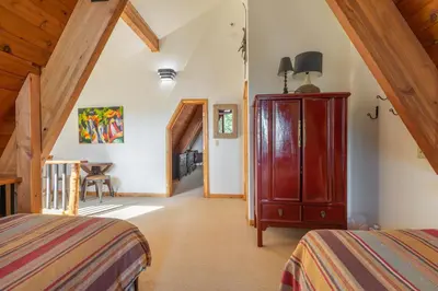 a bedroom with a bed and a dresser in a room at Ember Ridge Retreat by Tahoe Getaways - 3BR Pet-Friendly Carnelian Bay Rental w Fenced Yard, Ping Pong, Hot Tub, Near Northstar in Carnelian Bay