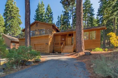 a log home in the woods with a driveway at Fireside Lodge at Northstar By Tahoe Getaways - 4BR w Hot Tub, HOA & Ski Shuttle in Truckee