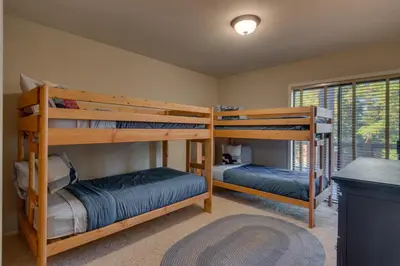 a bedroom with two bunk beds in a house at Fireside Lodge at Northstar By Tahoe Getaways - 4BR w Hot Tub, HOA & Ski Shuttle in Truckee