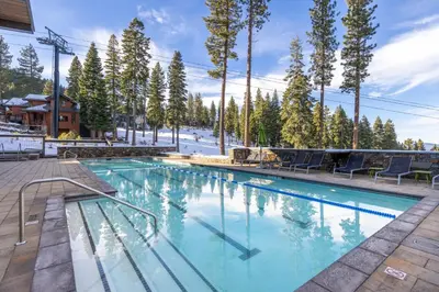 a pool at a resort with trees at Gondola Getaway- Ski-in Ski-out - Luxury 4 BR, Private Hot Tub, HOA Amenities in Truckee