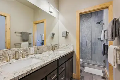 a bathroom with two sinks and a shower at Graystone Retreat - Modern Retreat w Hot Tub & HOA Amenities in Truckee