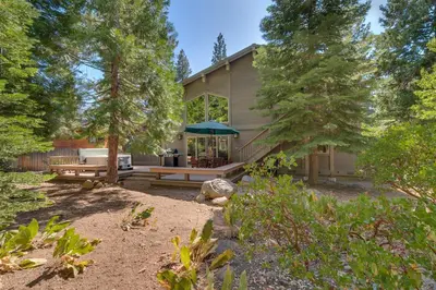 a house with a picnic table in the yard at High Sierra at Dollar Point - Private Hot Tub, Close to Ski Resorts, Pet Friendly! in Tahoe City