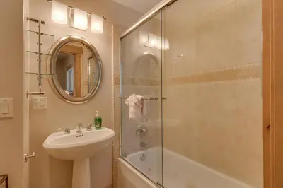 a bathroom with a sink and a glass shower at High Sierra at Dollar Point - Private Hot Tub, Close to Ski Resorts, Pet Friendly! in Tahoe City